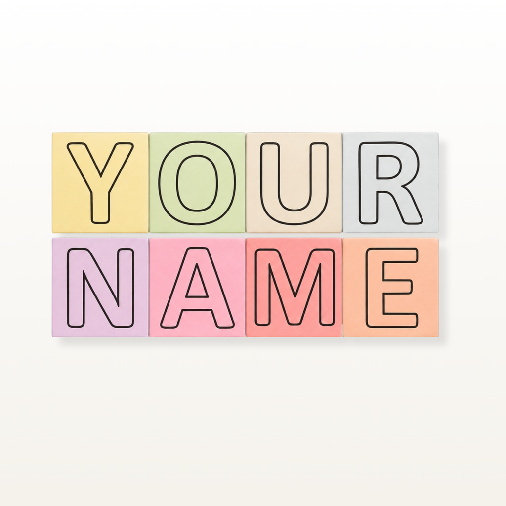 Six pastel-colored square letter tiles arranged in two rows to spell out 'YOUR NAME' in outline letters, set against a light beige background.